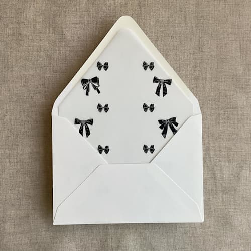 This is a black wedding envelopes by Ivory Invitations called black ribbon bow printed vellum liner for a7 euro flap envelope | pack of 10 in standard
