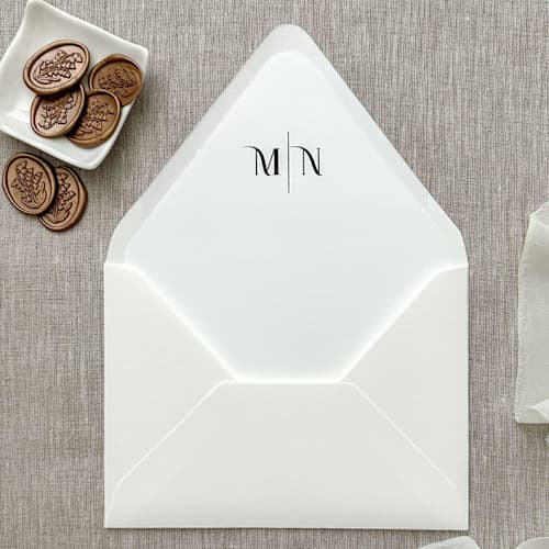 This is a black wedding envelopes by Orchid Studio called customizable initials euro flap envelope liner for a7 (5x7”) invitations | set of 10 in standard