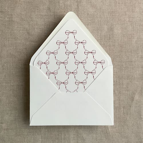 This is a red wedding envelopes by Ivory Invitations called red ribbon bows printed envelope liner for a7 euro flap envelope | pack of 10 in standard