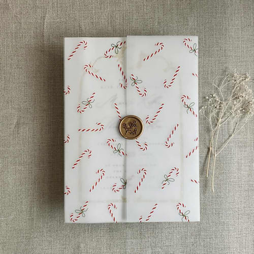 This is a multicolorassorted-colors vellum wedding invitations by Ivory Invitations called holiday candy cane printed vellum wrap for 5x7 card | pack of 10 in standard