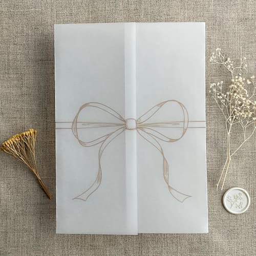 This is a beige vellum wedding invitations by Ivory Invitations called cashmere ribbon bow printed vellum wrap for 5x7 card | pack of 10 in standard