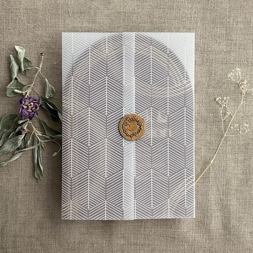 This is a white vellum wedding invitations by Ivory Invitations called minimalist hexagon chevron abstract leaves printed vellum wrap for 5x7 card | pack of 10 in standard