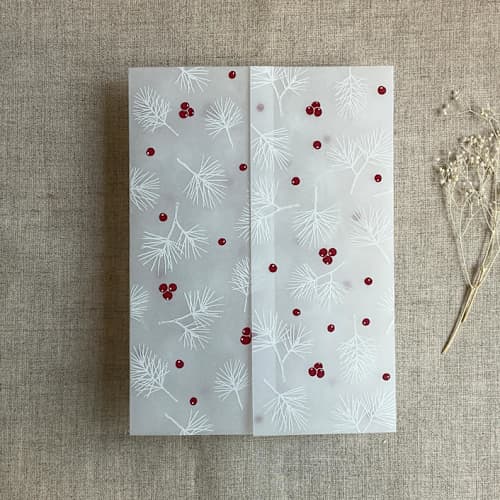 This is a white vellum wedding invitations by Ivory Invitations called holly berries white pine leaves printed vellum wrap for 5x7 card | pack of 10 in standard