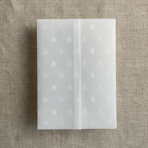 This is a white vellum wedding invitations by Ivory Invitations called white snow flake and forest vellum wrap for 5x7 card | pack of 10 in standard