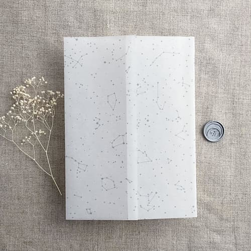 This is a blue vellum wedding invitations by Ivory Invitations called stella celestial steel blue color printed vellum wrap for 5x7 card | pack of 10 in standard