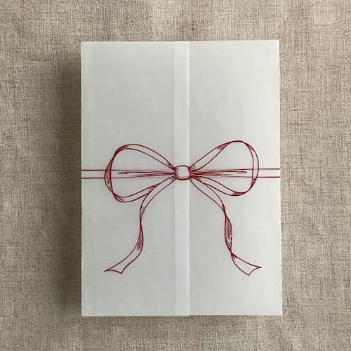 This is a red vellum wedding invitations by Ivory Invitations called red ribbon bow printed vellum wrap for 5x7 card | pack of 10 in standard