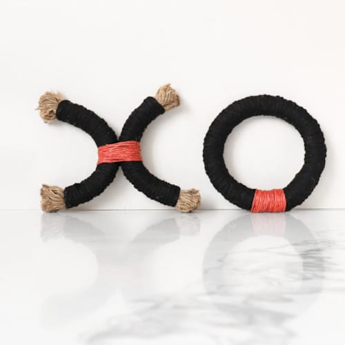 This is a red sculpture art by Bharti Trivedi called red xoxo rope decor in standard