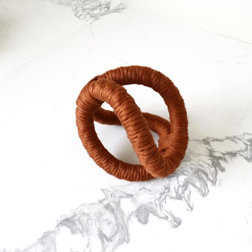 This is a brown sculpture art by Bharti Trivedi called infinity sculpture-terracotta in standard