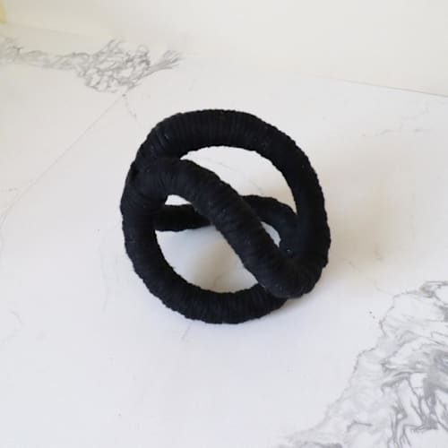This is a black sculpture art by Bharti Trivedi called infinity loop table sculpture- black in standard
