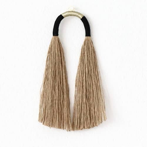 This is a black sculpture art by Bharti Trivedi called small jute tassel with gold in standard