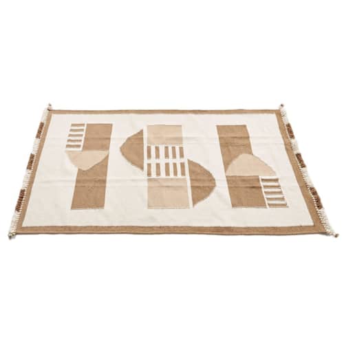This is a beige rugs by Anjali Purohit called dyoon handloom rug in standard