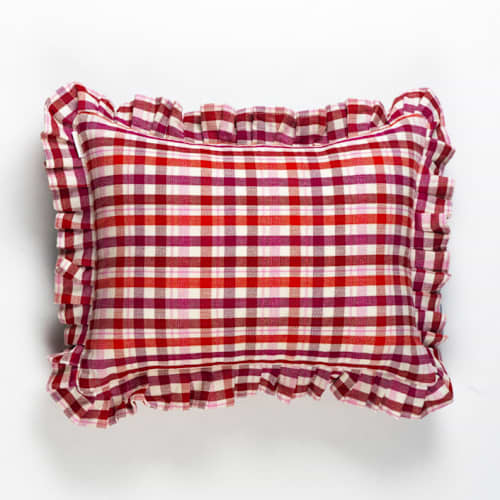 This is a red throw pillows by Archive New York called noel plaid handwoven cotton ruffle pillow in standard