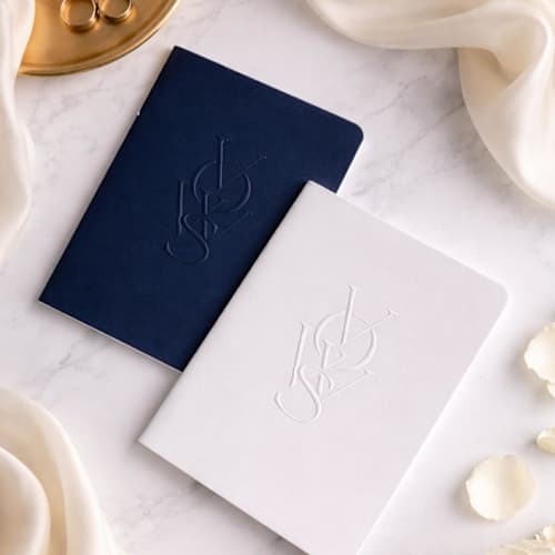 This is a blue vow books by Eva Tadros called luxe embossed unisex vow books, set of two - navy & white in standard