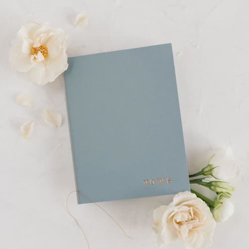 This is a blue vow books by Studio Lavender called dusty blue wedding vow books, set of two in standard