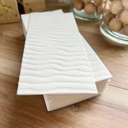 This is a natural decorative paper napkins by Prêt-à-PartyNY called luxe linen debossed napkins | mod waves in simply white in standard