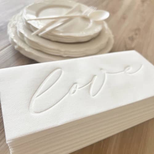 This is a natural decorative paper napkins by Prêt-à-PartyNY called letterpress luxe linen | love in simply white in standard