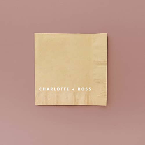 This is a beige decorative paper napkins by ForYourParty called simple block names statement napkin, cocktail size, set of 50 in standard