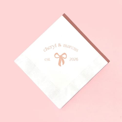 This is a white decorative paper napkins by ForYourParty called eternal bond bow napkin, cocktail size, set of 100 in standard