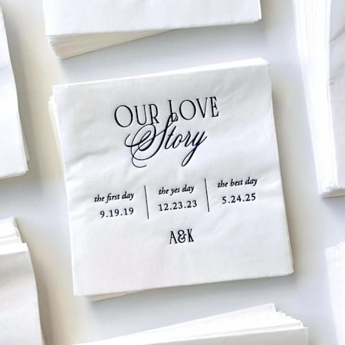 This is a white decorative paper napkins by Alyssa Cook called personalized our love story cocktail napkins | wedding or engagement party napkins | set of 50 in standard