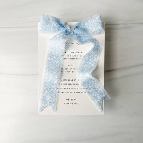 This is a blue wedding ribbon by Honey Silks Co called cotton ribbon - pale blue blooms 1" x 5 yards in standard