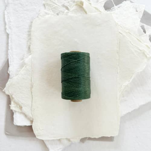 This is a green wedding ribbon by Jenny Sanders called forest green waxed linen twine, 2-ply in standard