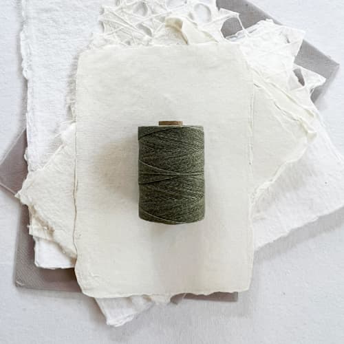 This is a green wedding ribbon by Jenny Sanders called sage waxed linen twine, 2-ply in standard