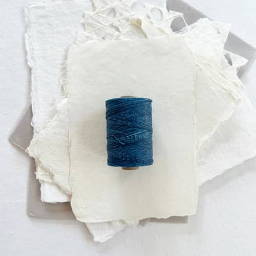 This is a blue wedding ribbon by Jenny Sanders called denim waxed linen twine, 2-ply in standard