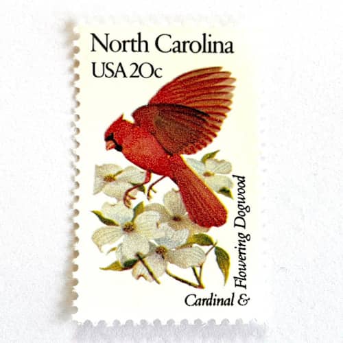 This is a red stamps by Heritage Post House called north carolina postage stamps | state bird and flower issue | cardinal & flowering dogwood | vintage unused usps postage 20c | pack of 10 in standard
