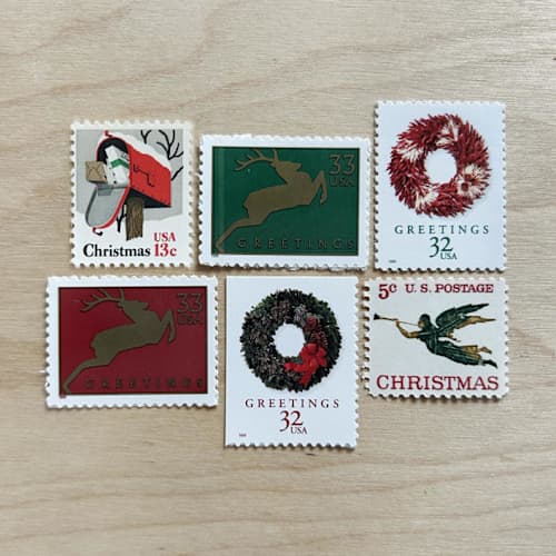 This is a red stamps by Kristen Melchor called 83 cents . christmas wreath vintage postage stamps . set of 5 in standard