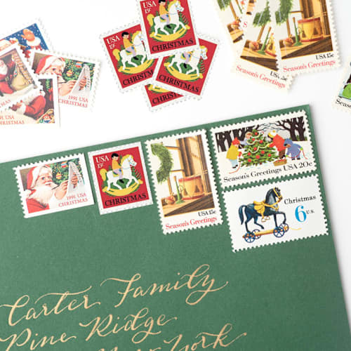 This is a green stamps by Flourish Fine Writing called christmas morning vintage postage set // set of 5 // unused // santa & toys in standard