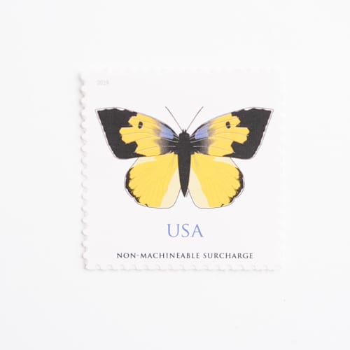 This is a yellow stamps by Flourish Fine Writing called forever dogface butterfly stamps // set of 10 // 1 ounce plus non-machinable // unused postage in standard