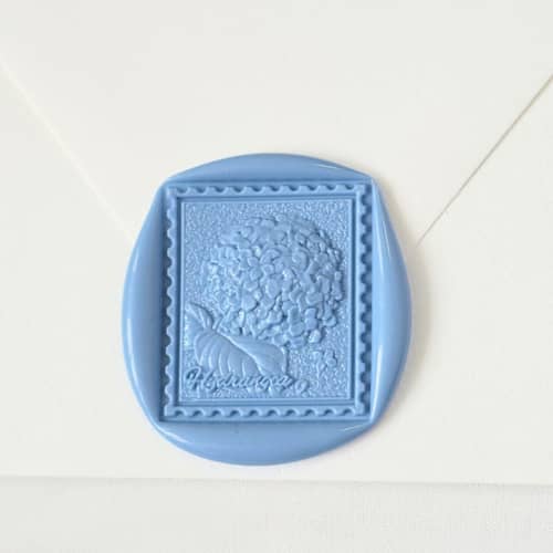 This is a multicolor wax seals by Inkspiringletters called hydrangea postage- customizable color- set of 25 hand-crafted wax seals in standard