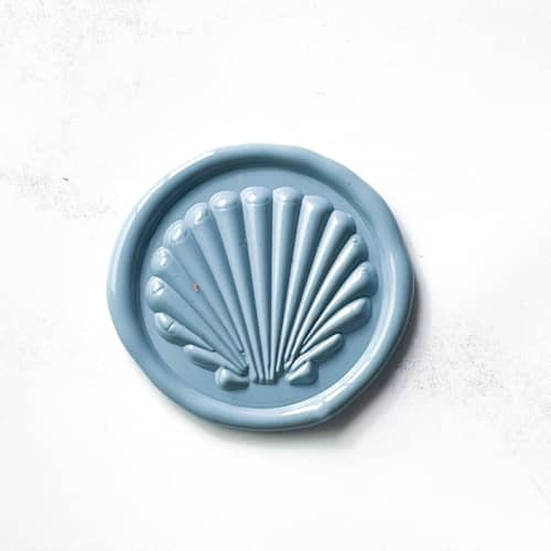 This is a blue wax seals by Abby Choi called seashell in dusty blue pack of 10 in standard