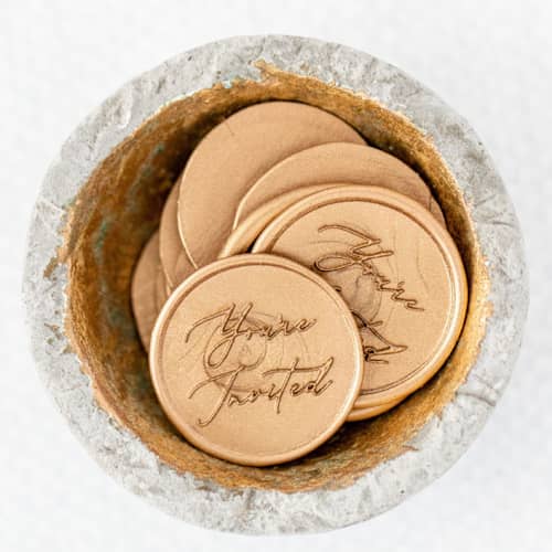 This is a gold wax seals by Lindsey Cain called you're invited (sold in sets of 10) in standard