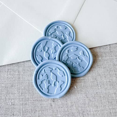 This is a blue wax seals by Orchid Studio called dusty blue graduation wax seal - graduation cap throw | set of 10 in standard