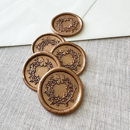 This is a gold wax seals by Orchid Studio called antique gold christmas wreath wax seal sticker | set of 10 in standard