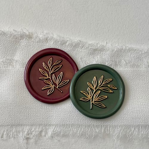 This is a multicolorassorted-colors wax seals by Vee called custom olive branch wax seals with gold accent (set of 10) in standard