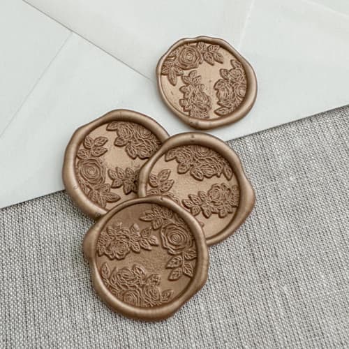 This is a gold wax seals by Orchid Studio called antique gold roses wax seal stickers | set of 10 in standard