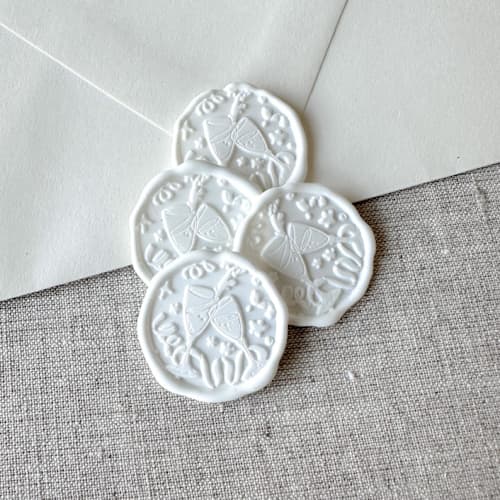 This is a white wax seals by Orchid Studio called white celebration wax seal sticker - champagne toast | set of 10 in standard