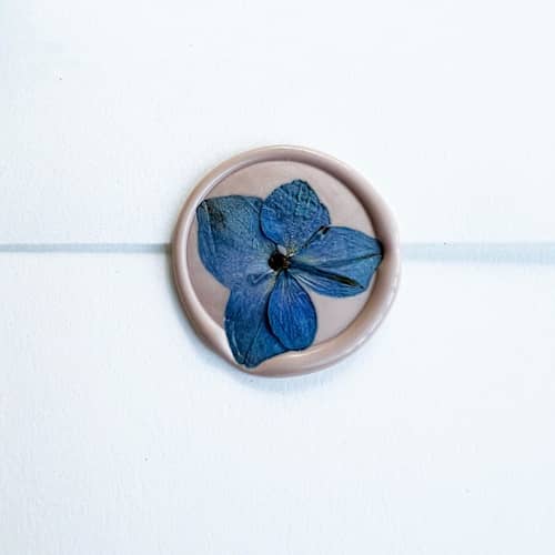 This is a blue wax seals by Caitlin Home called blue hydrangea wax seal in pink | pack of 10 in standard