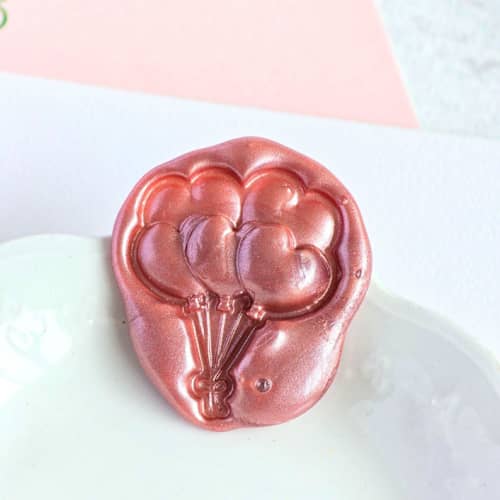 This is a multicolor wax seals by Inkspiringletters called love is in the air- customizable color- set of 25 hand-crafted wax seals in standard