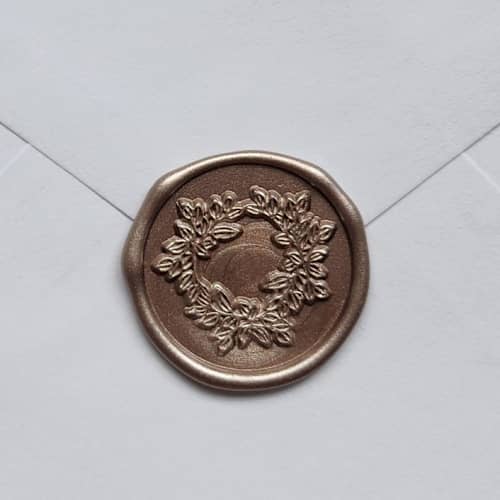 This is a gold wax seals by MC silverlinings called customizable color wreath self-adhesive wax seals, set of 5 in standard