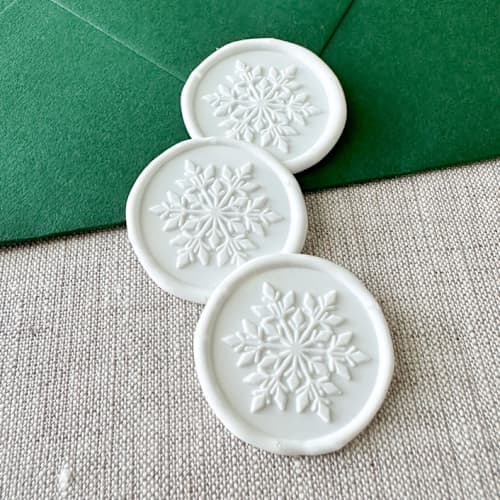 This is a white wax seals by Orchid Studio called white christmas snowflake wax seal sticker | set of 10 in standard