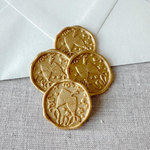 This is a multicolorassorted-colors wax seals by Orchid Studio called customizable color celebration wax seal sticker - champagne toast | set of 10 in standard