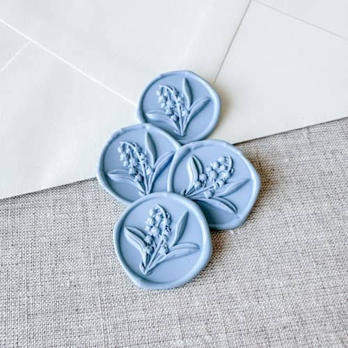 This is a blue wax seals by Orchid Studio called dusty blue lily of the valley 3d wax seal stickers | set of 10 in standard