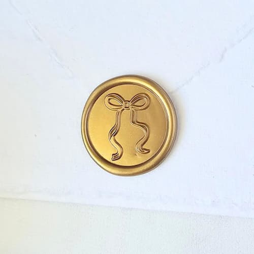 This is a multicolor wax seals by Inkspiringletters called long-tailed bow- customizable color- set of 25 hand-crafted wax seals in standard