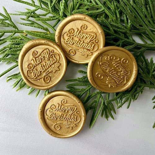 This is a gold wax seals by Honey Silks Co called merry christmas gold wax seal - set of 10 in standard