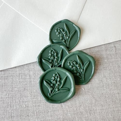 This is a green wax seals by Orchid Studio called olive green lily of the valley 3d wax seal stickers | set of 10 in standard