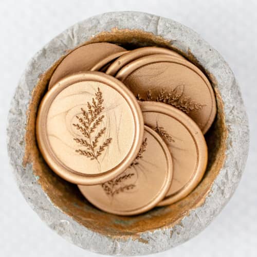 This is a gold wax seals by Lindsey Cain called english garden (sold in sets of 10) in standard