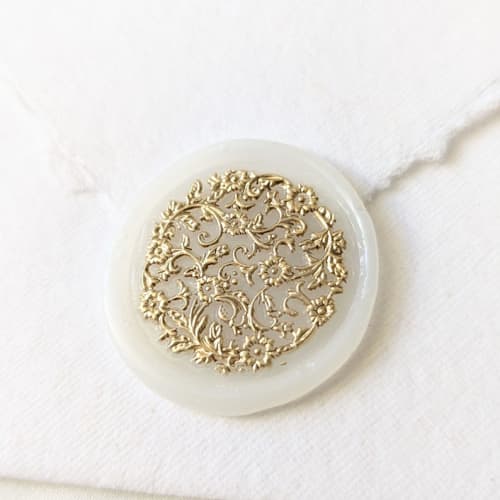 This is a clear wax seals by Inkspiringletters called french lace- gilded on vellum- set of 25 hand-crafted wax seals in standard